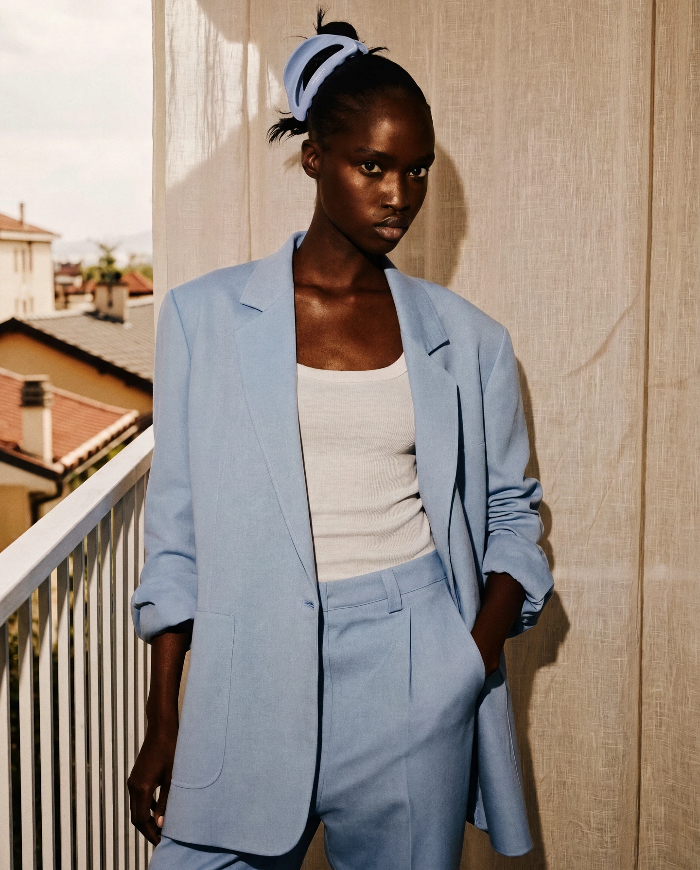 Blue mouelle editorial: portrait with a pale blue blazer and blue hair clip.
